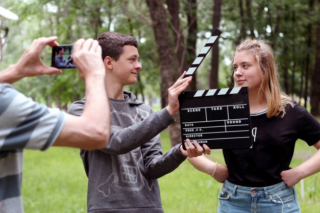 Students recording a film on their phone