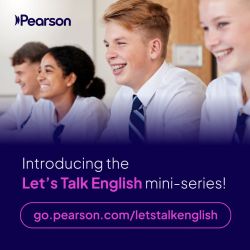 Students in a classroom smiling.