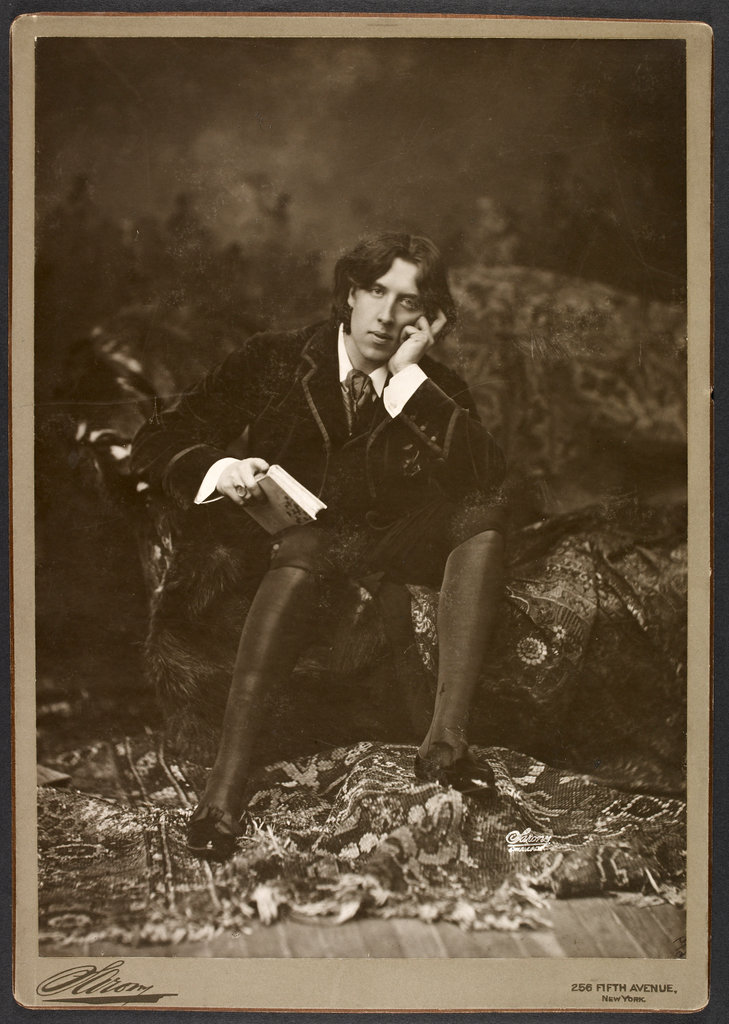Oscar Wilde sitting on a sofa