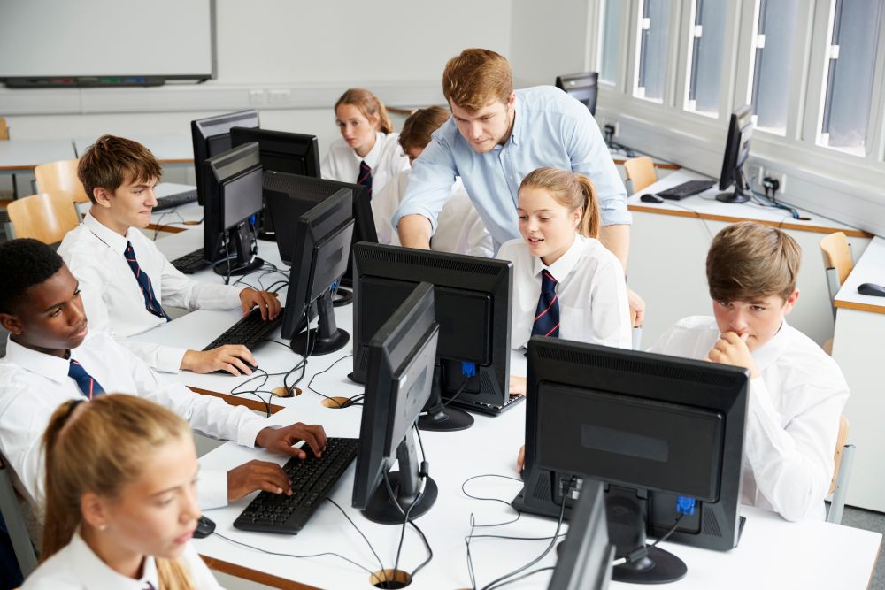 Teacher and students in an IT room.